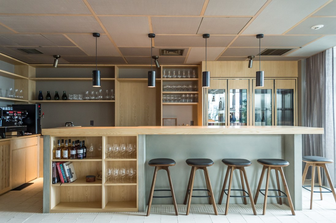 Restaurant bar area with custom stools and pendant lighting fixtures in modern design