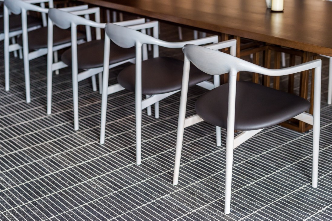 Private dining room with Jari chairs and brick-tile flooring showcasing restaurant's design aesthetic