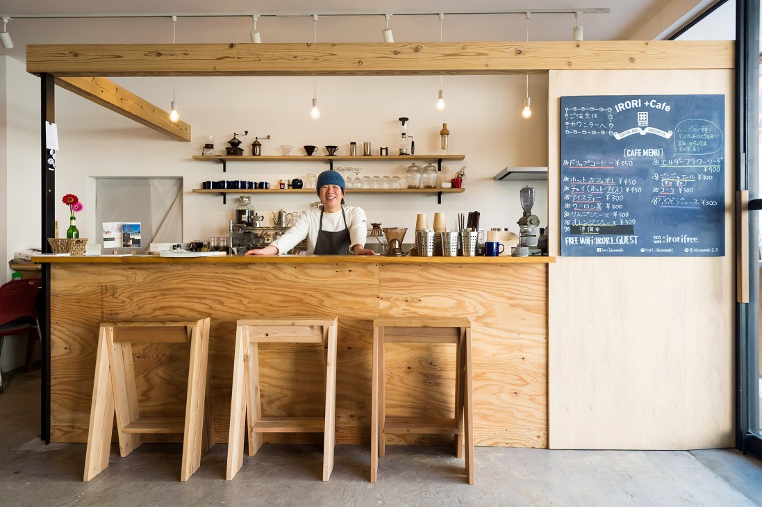 Irori Café counter with wooden AA Stools, shelving, and barista behind counter