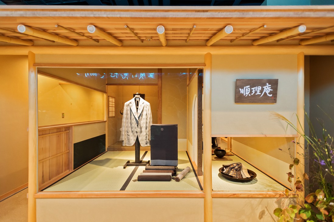 Traditional Japanese shop interior with white jacket on stand and wooden furnishings for Junrian brand