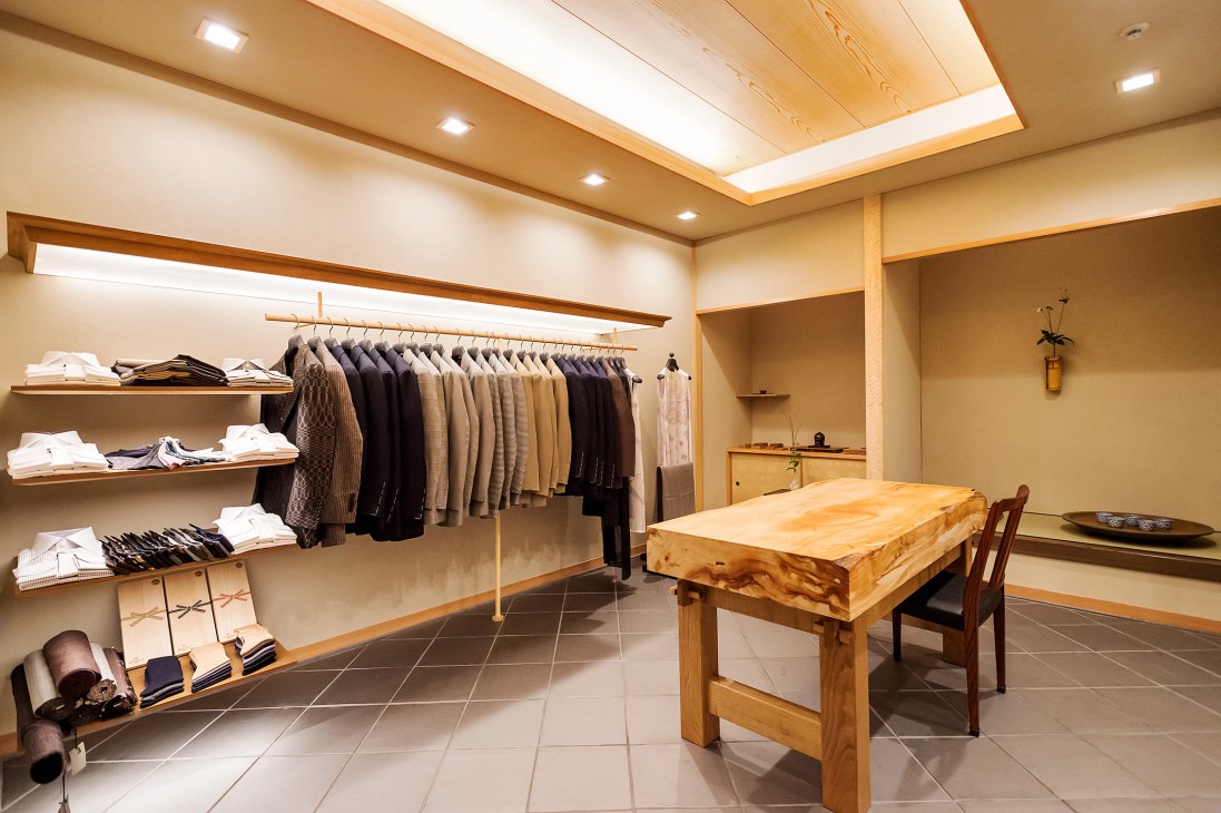 Junrian brand interior showing clothing racks and ancient cedar table in traditional Japanese shop design