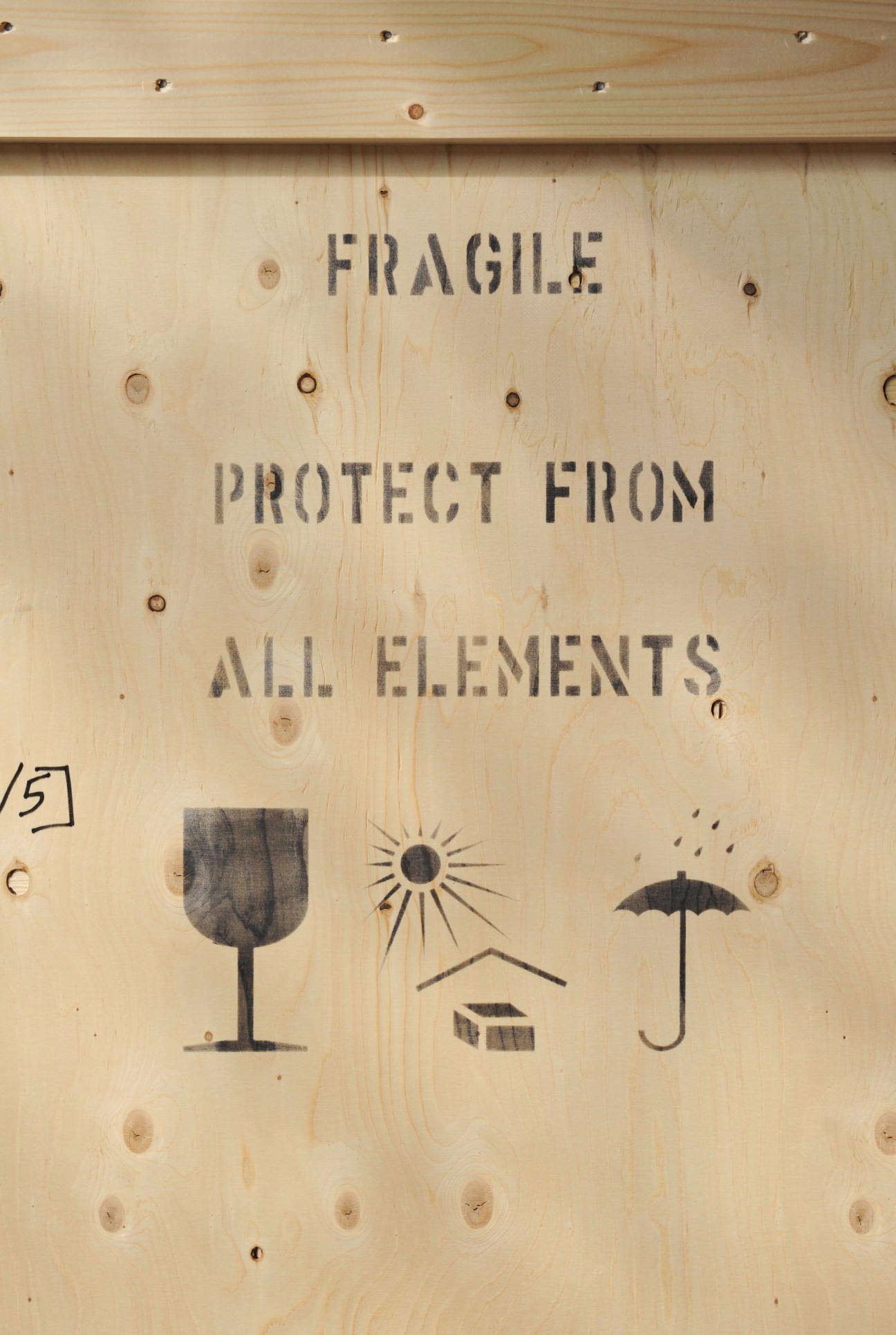Custom wooden art shipping crate with "Fragile" and "Protect From All Elements" text and warning icons.