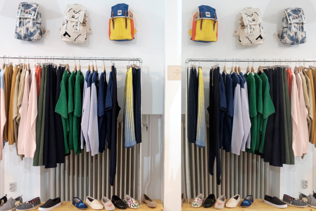 Interior of Dóri Tomcsanyi's boutique displaying colorful backpacks and clothing on rails.