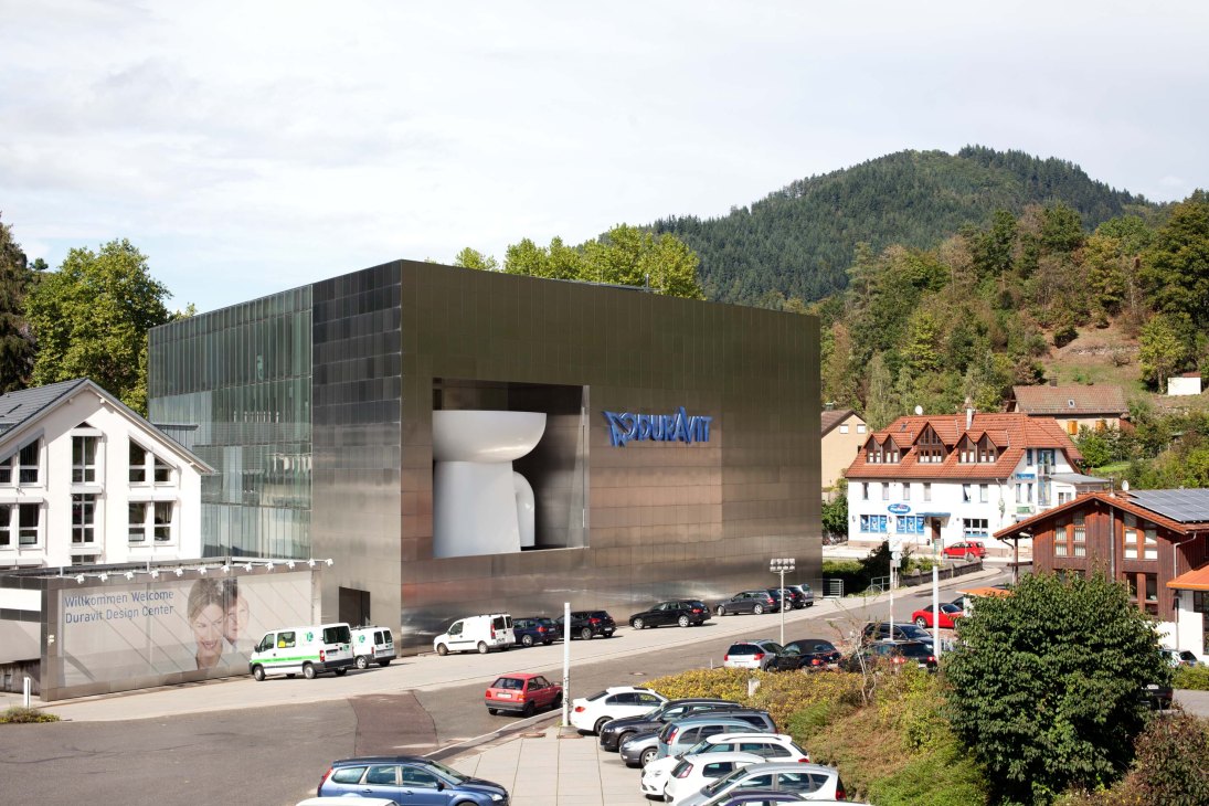 Modern Duravit Design Center building with oversized toilet display in Black Forest valley setting.