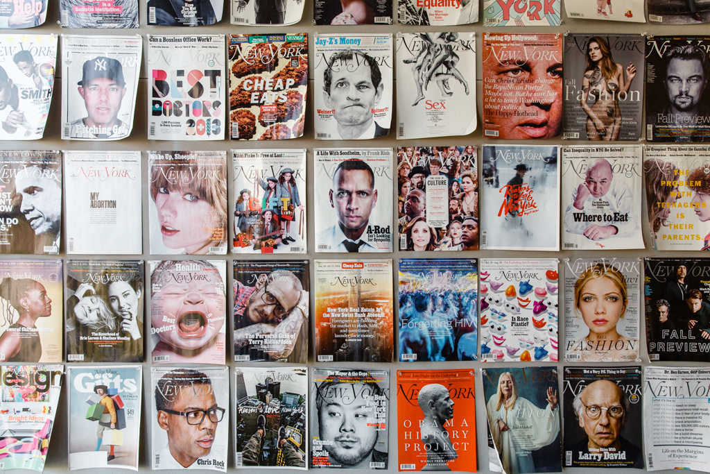 Collection of New York magazine covers displayed on a wall, showing various issues with different cover subjects and designs.