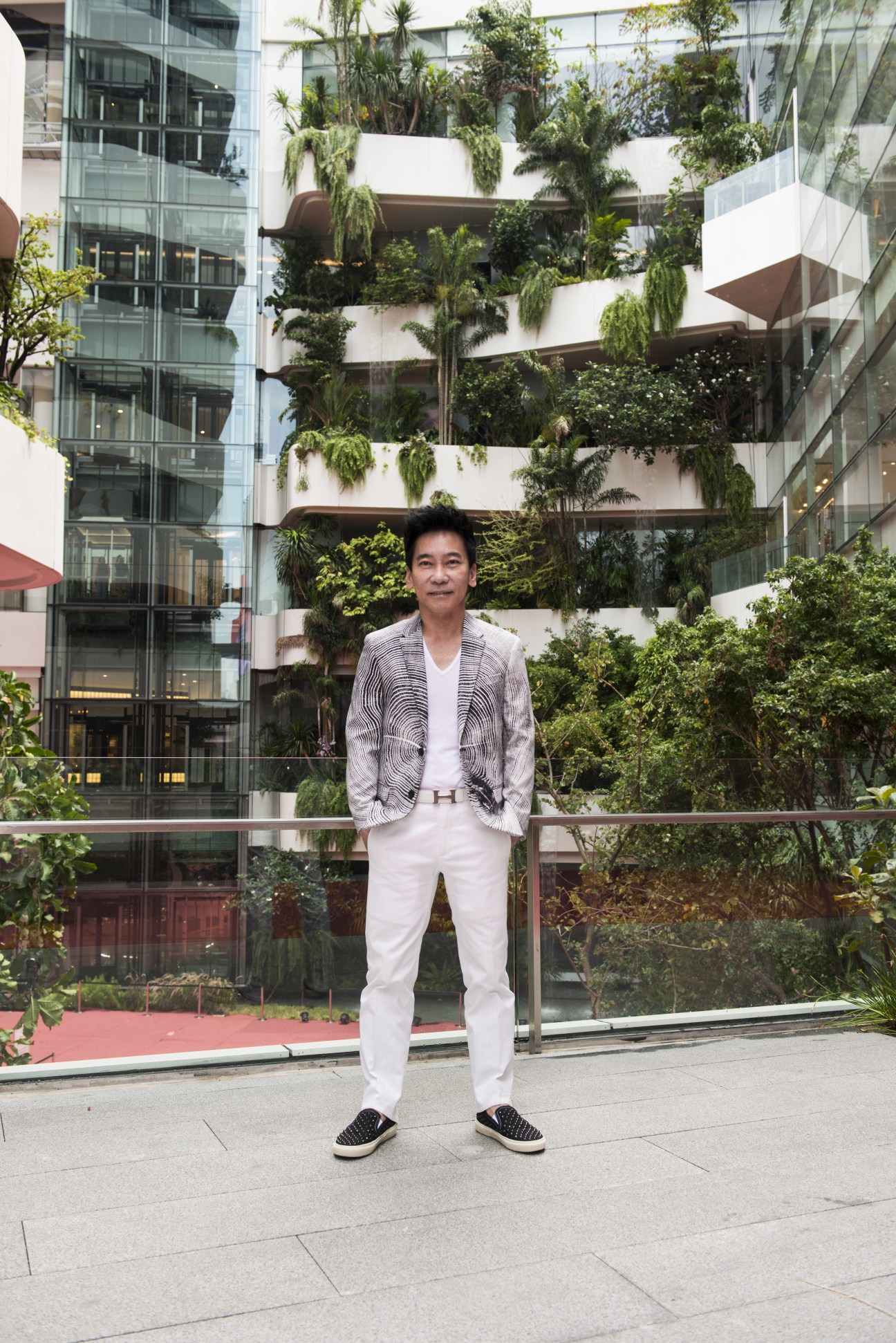 Kriengsak Tantiphipop stands in front of EmQuartier's cascading green-planted terraces in Bangkok.