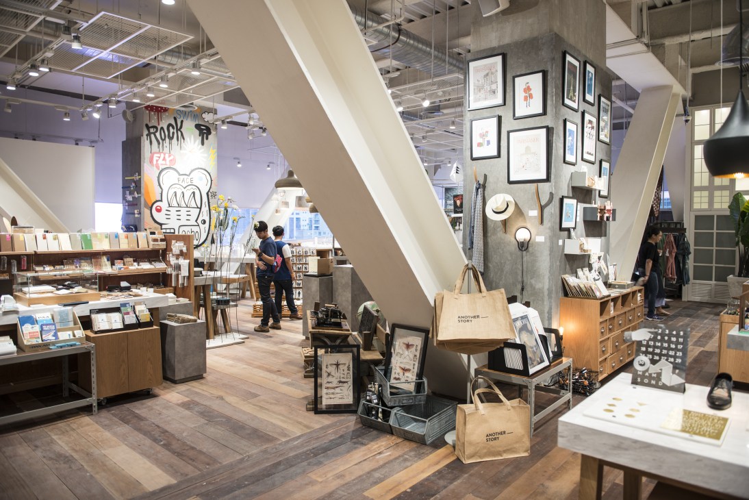 Another Story retail space at EmQuartier with books, artwork, and decorative items displayed.