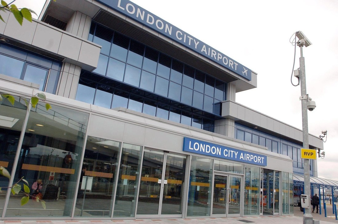 London City Airport terminal building exterior with glass facade and blue signage.