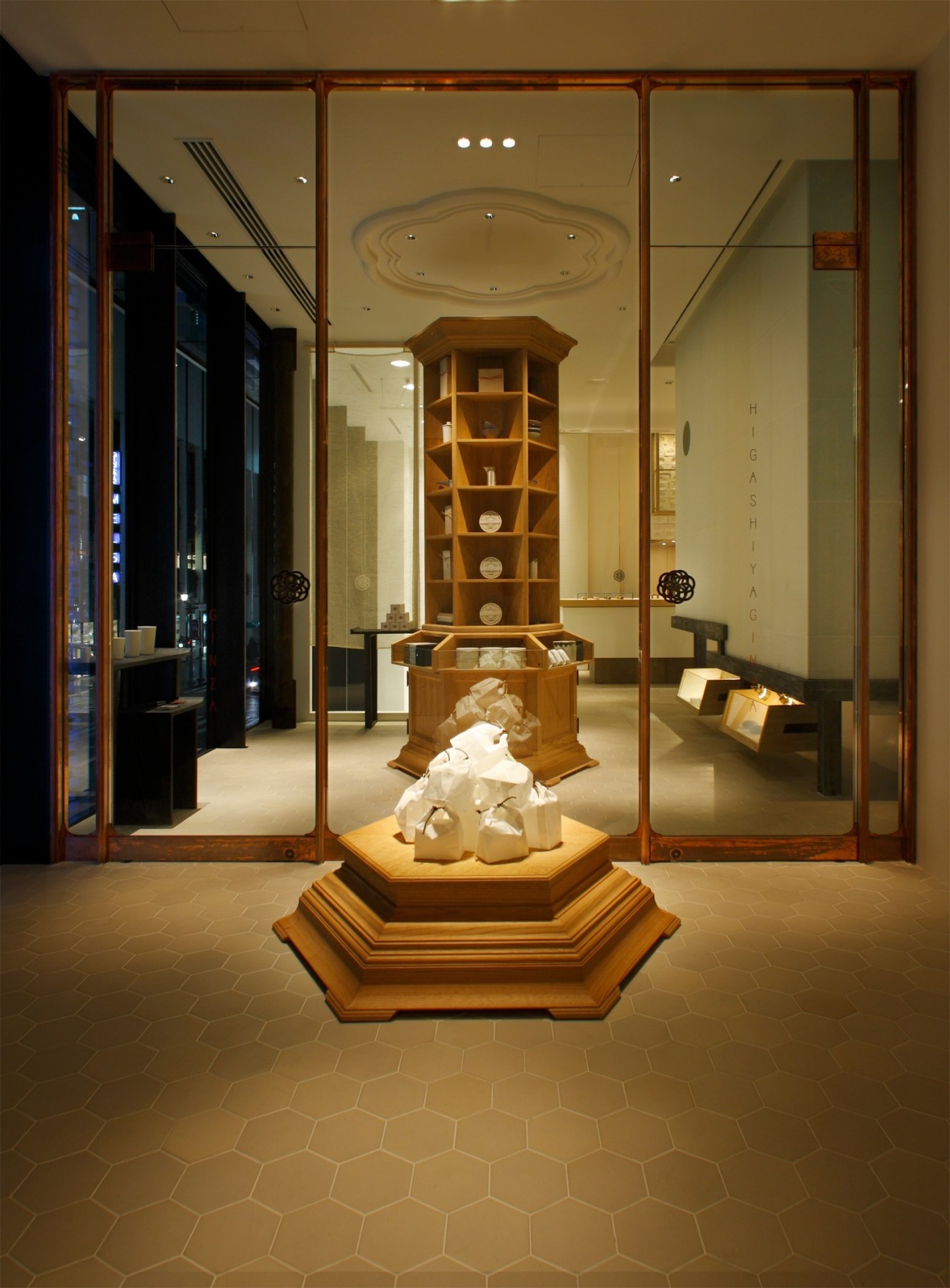 Higashiya tea salon entrance in Ginza, Tokyo, featuring wooden display cases and minimalist design.