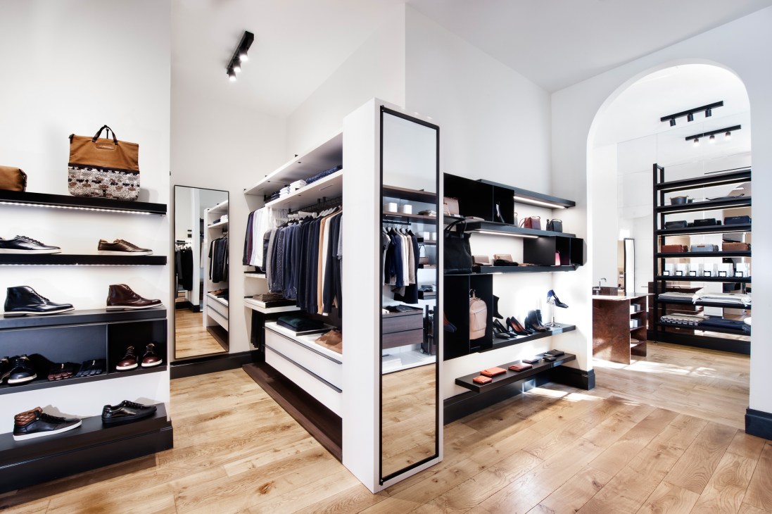 Want Les Essentials retail store interior with minimalist shelving displaying shoes, bags, and clothing in New York.