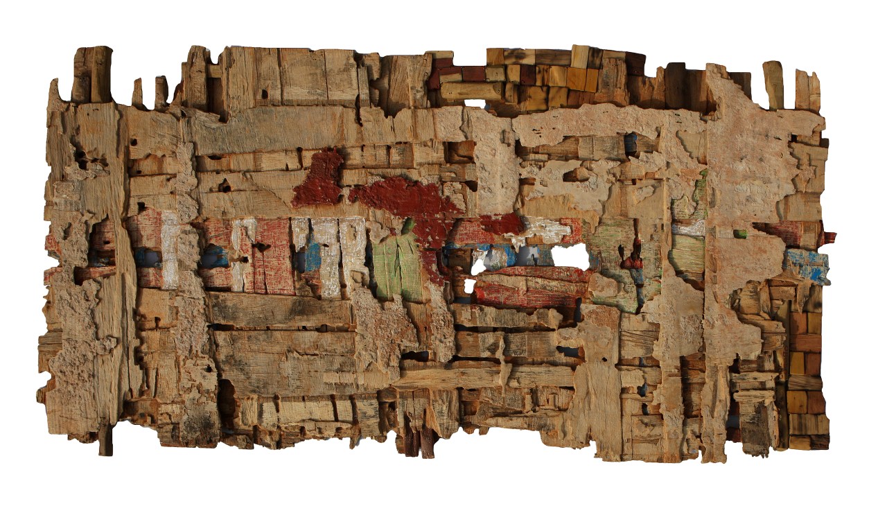 Wooden and acrylic artwork by Eva Obodo featuring patched wood pieces with red and blue paint remnants.