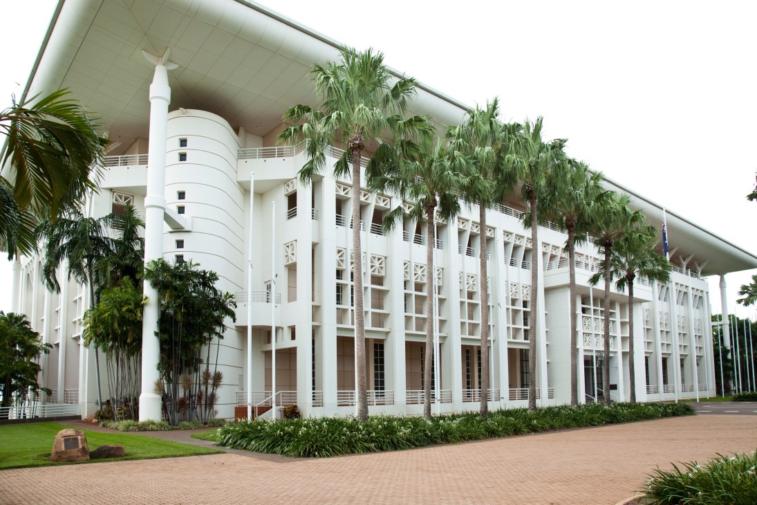 Darwin's Parliament House, a white modern building with palm trees and tropical landscaping.