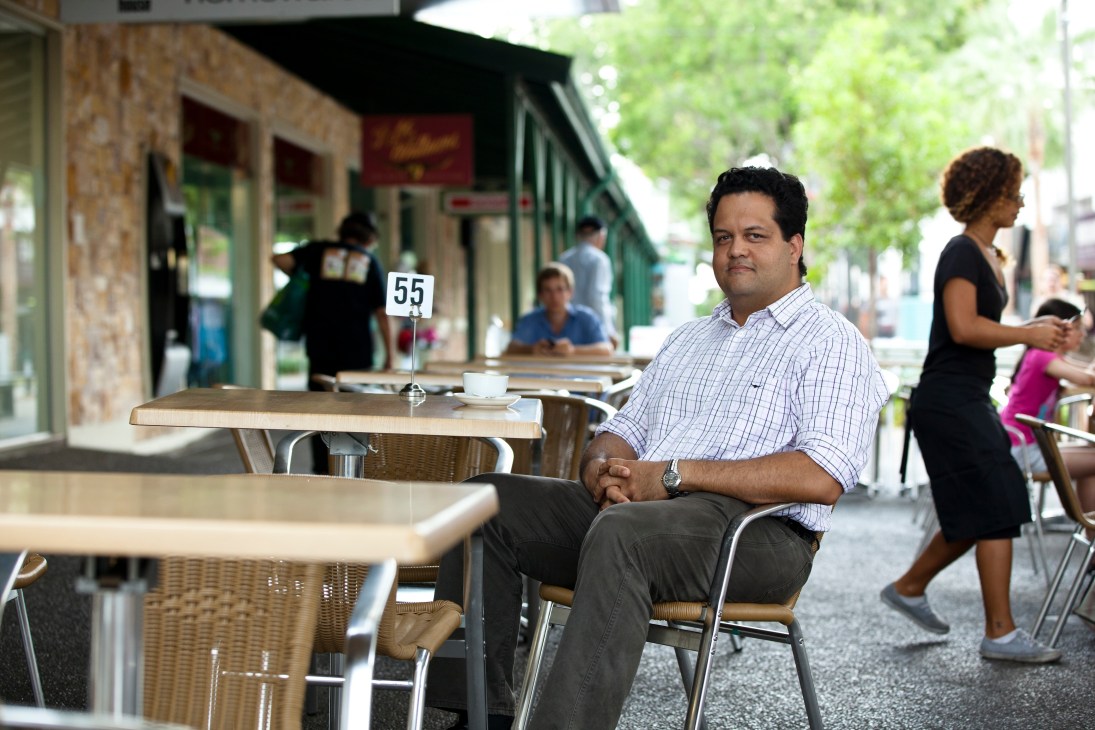 Nigel Browne, lawyer and Aboriginal traditional owner, sits at an outdoor café table on a Darwin street.