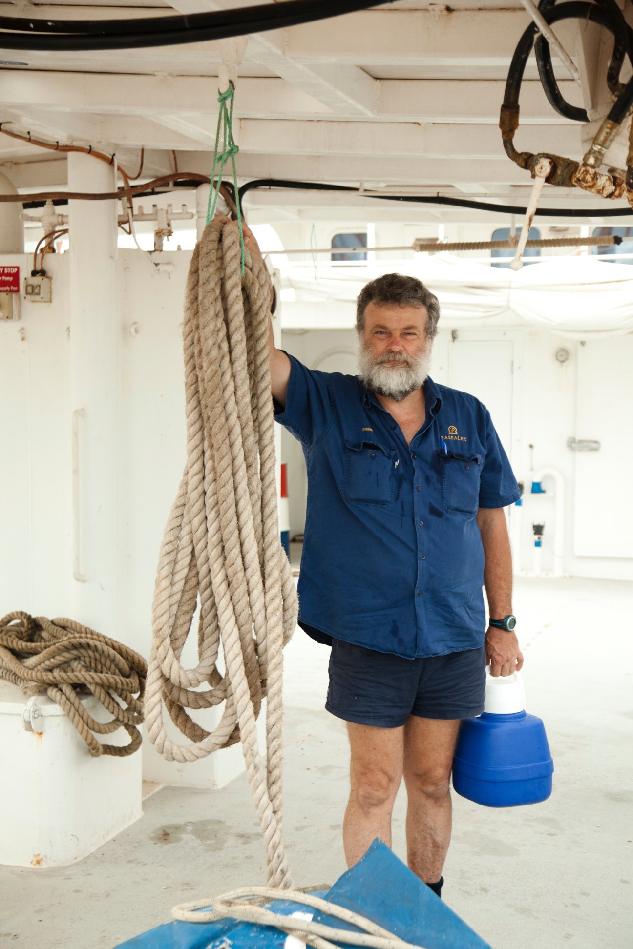 A worker holds a coiled rope aboard a vessel at Darwin's prawn and pearling fleet in Frances Bay.