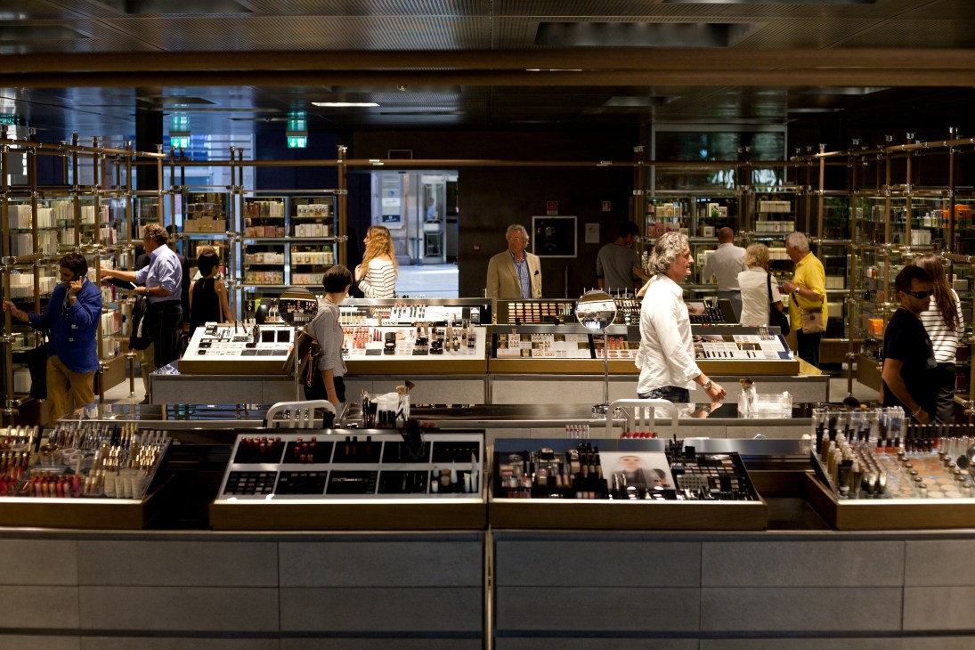 Interior of Excelsior department store in Milan with cosmetics counter, shelving, and shoppers browsing