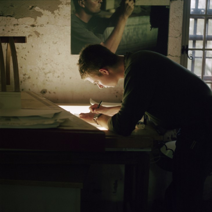 Student Edwin Dargan Johnston works at a light box in a restoration workshop.