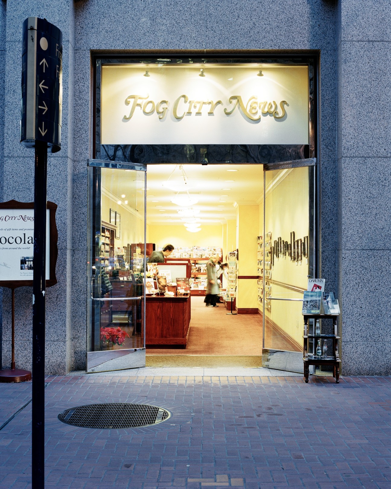Fog City News storefront with illuminated signage in San Francisco's financial district.