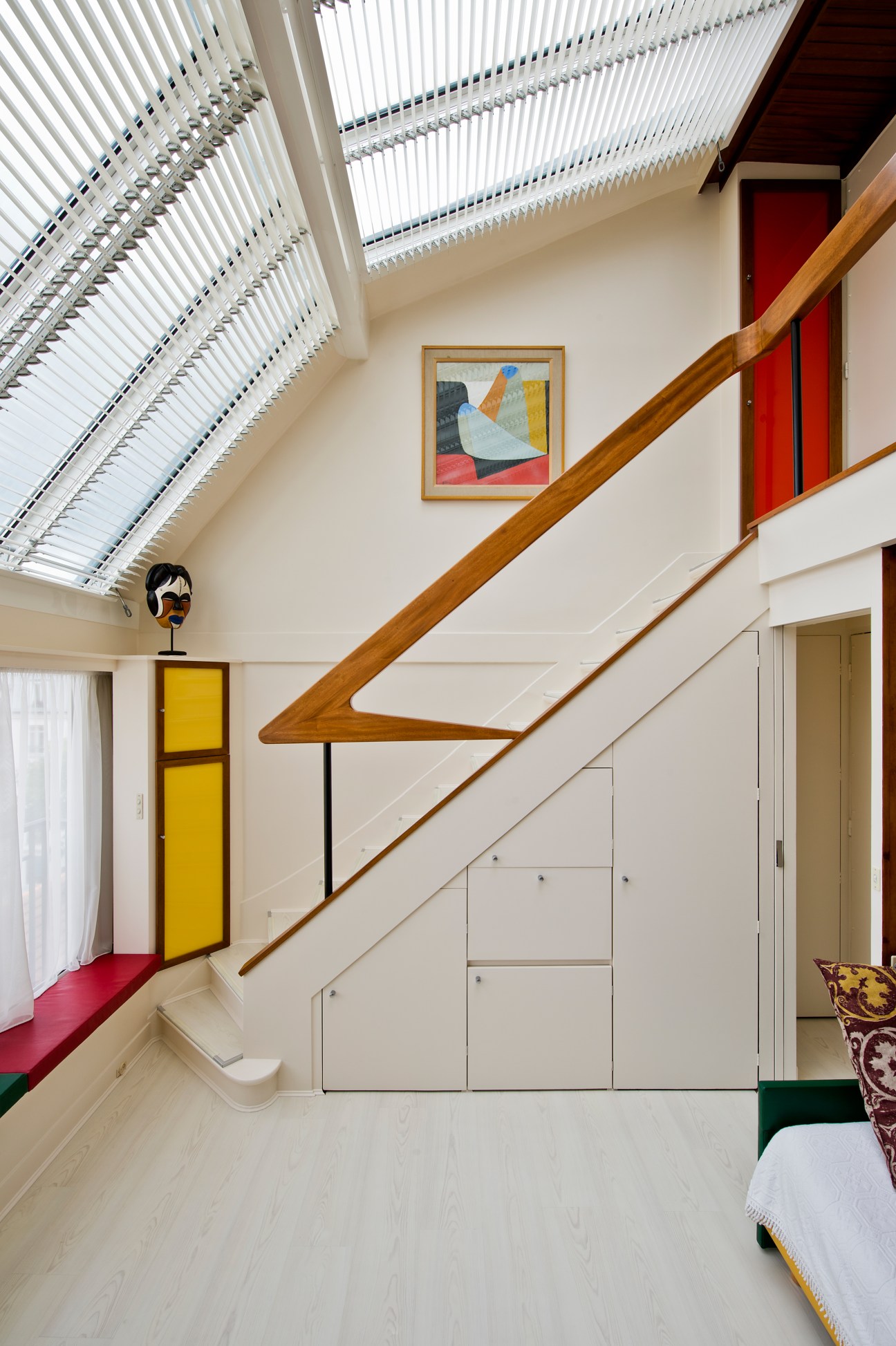 Mahogany staircase with wrought-iron base in modernist Paris apartment designed by Janette Laverrière