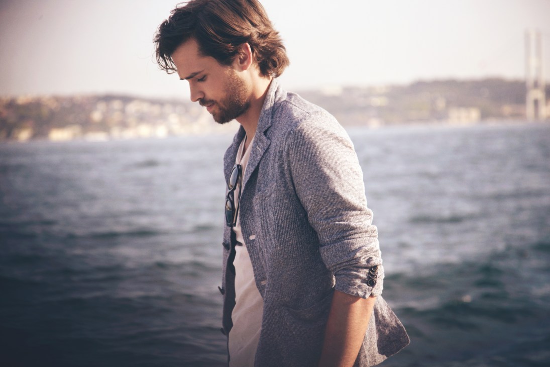 Man wearing Barena jacket and Sunspel t-shirt standing by the Bosphorus water.