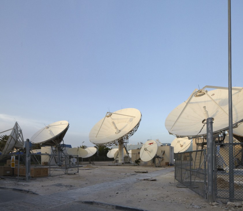 Multiple satellite dishes on the grounds of Al Jazeera studios in Doha transmit broadcasts worldwide.