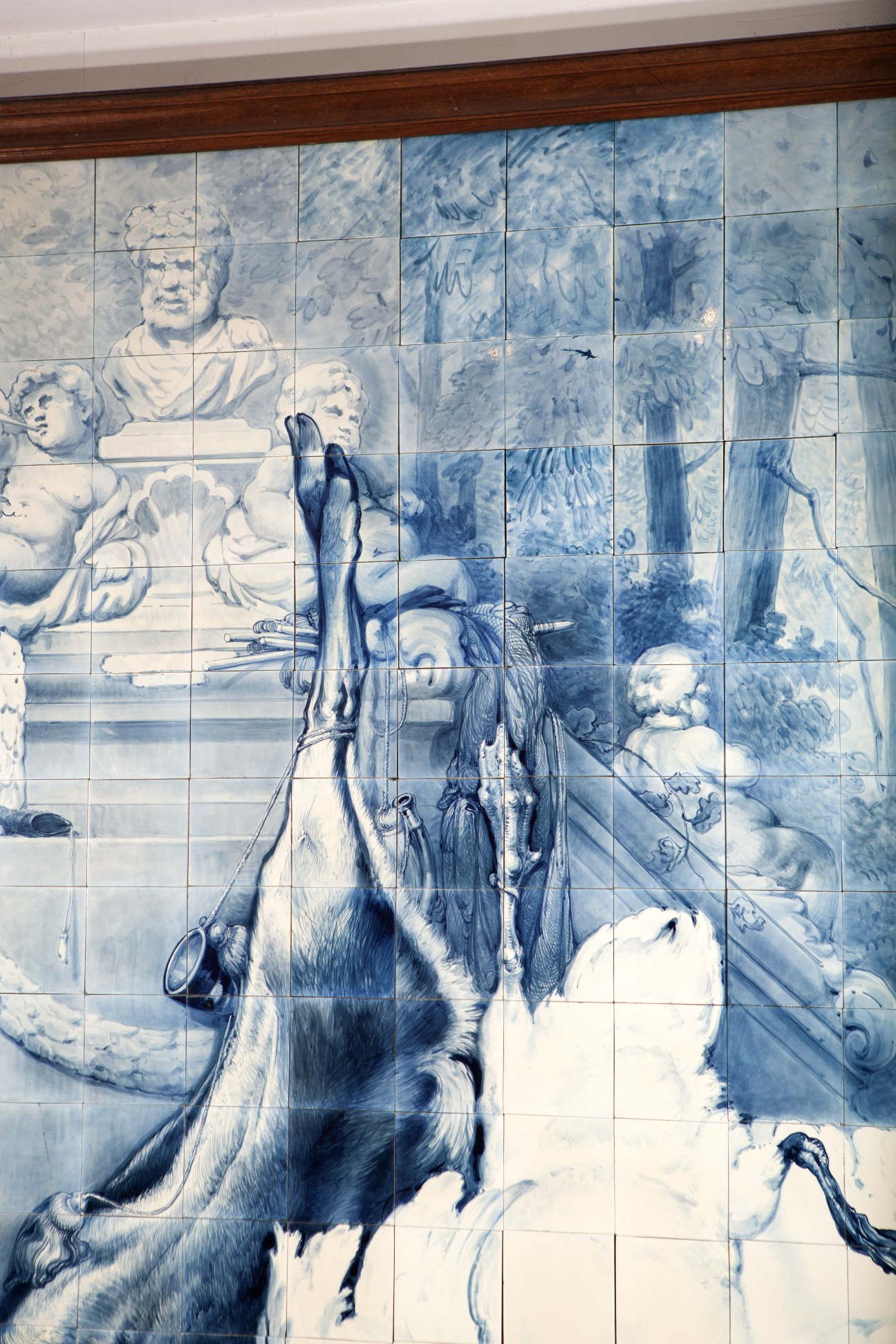 Blue and white Delft tile painting depicting classical figures and ornate details in traditional Dutch style.