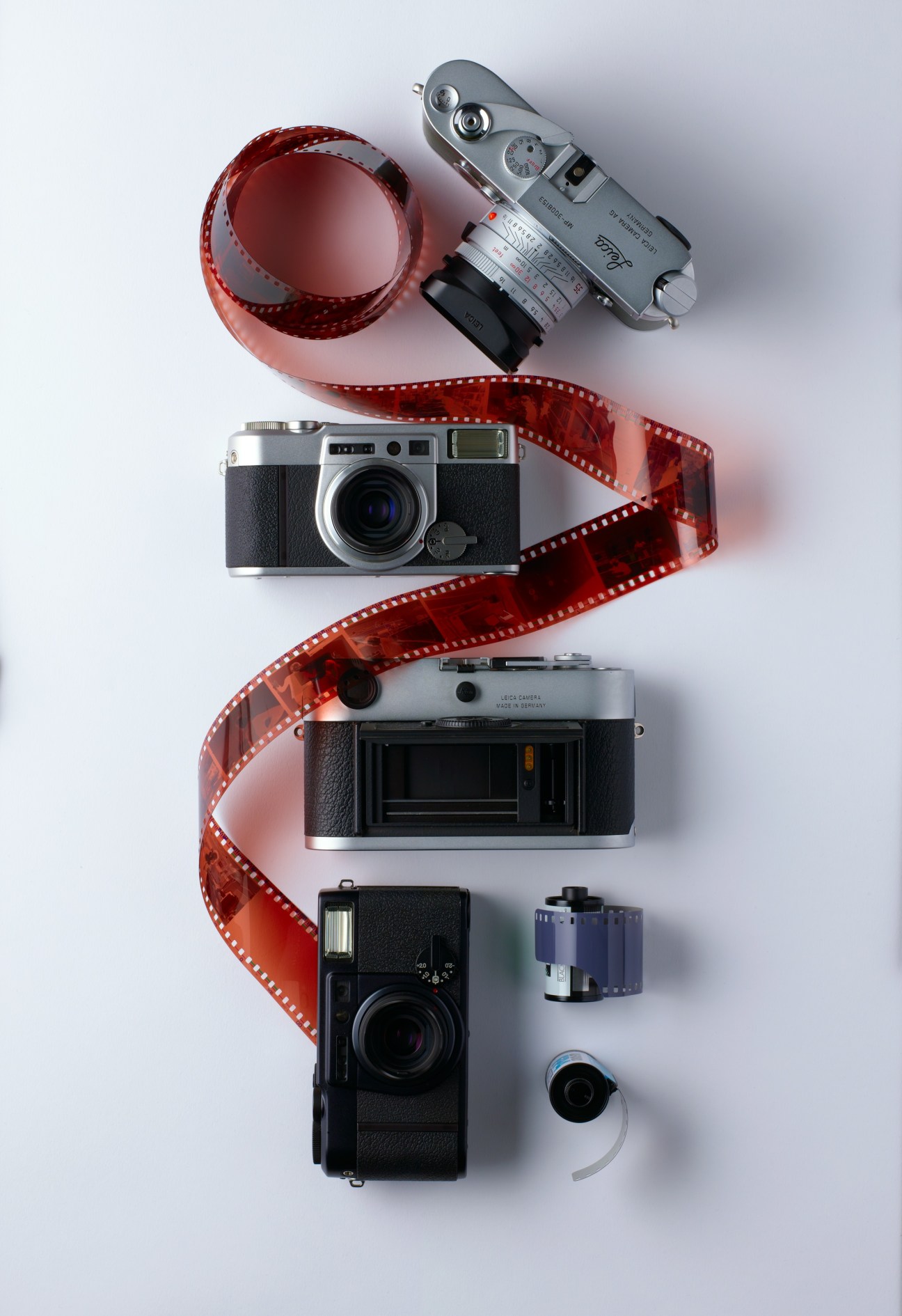 Vintage film cameras arranged vertically with red film strip, including Leica MP and M7 models and Fuji Klasse W cameras.
