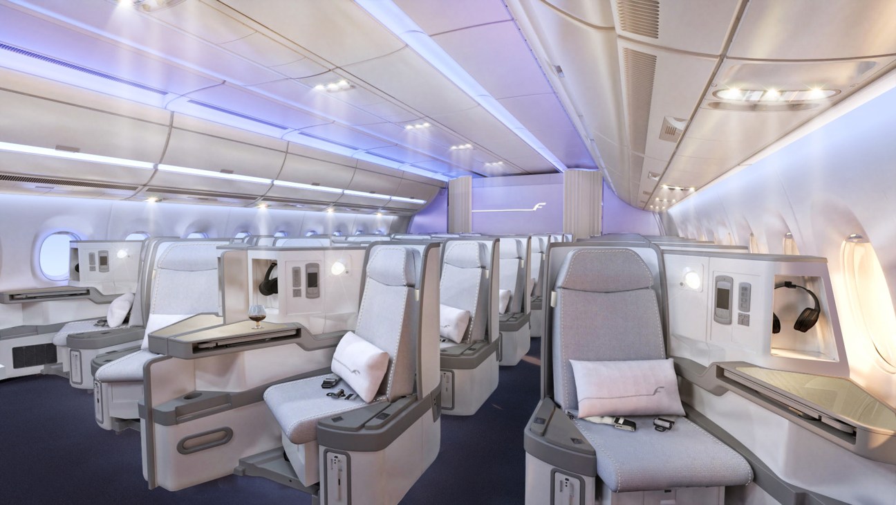 Finnair A350 business-class cabin with spacious seats, mood lighting, and modern interior design.