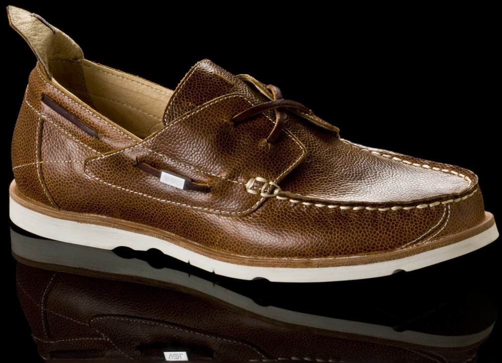 Brown leather The Vael Project moccasin/deckshoe hybrid with white sole against black background.