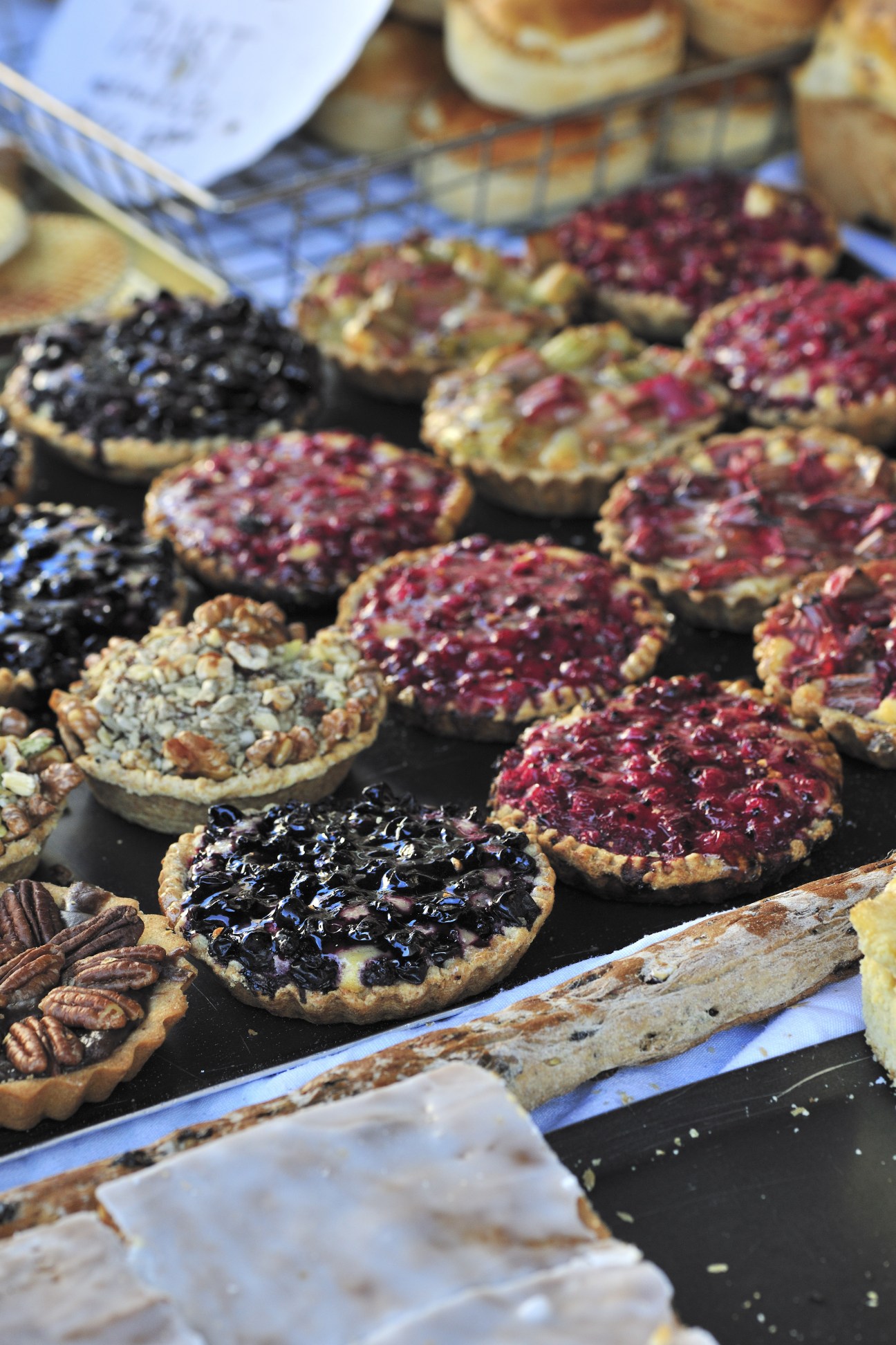 Display of various fruit tarts with berries and jam at Himschoot bakery in Ghent.