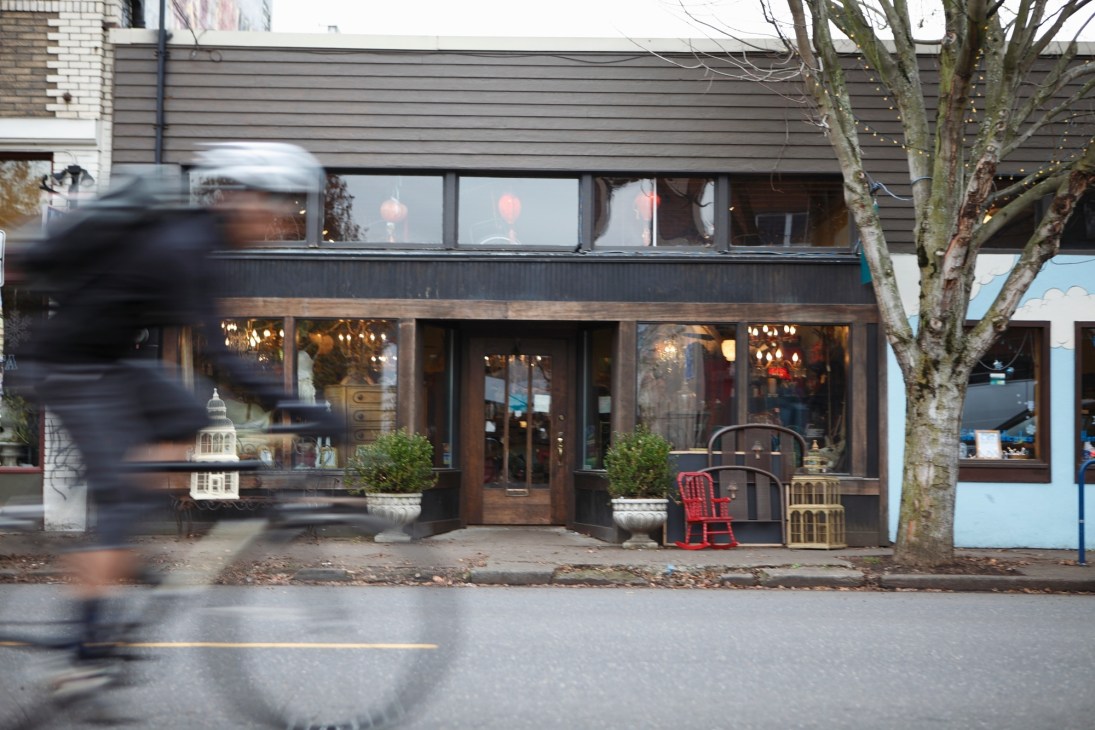 Flutter giftshop storefront on a North Portland street with dark wood facade and large windows.