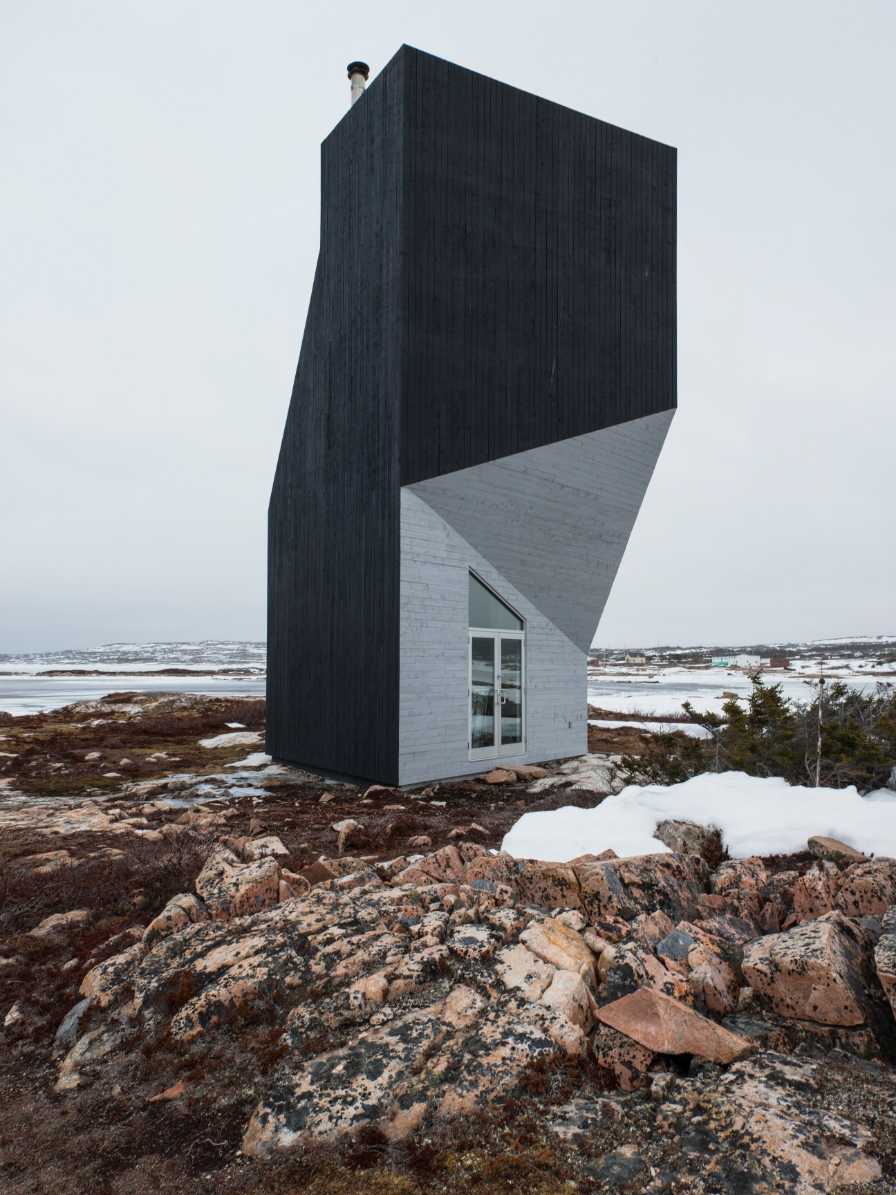 Tower Studio, a modernist structure with black timber cladding and concrete base on rocky Fogo Island coastline.