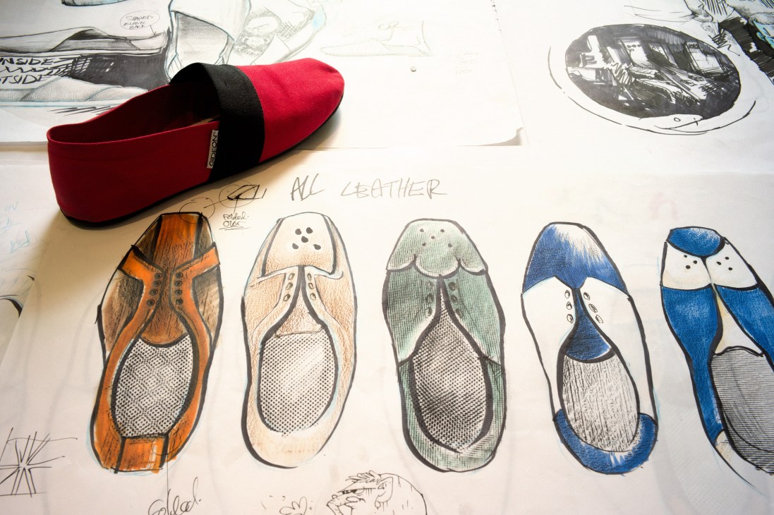 Gideon Shoes design sketches and prototype with red and black leather sneaker sample.