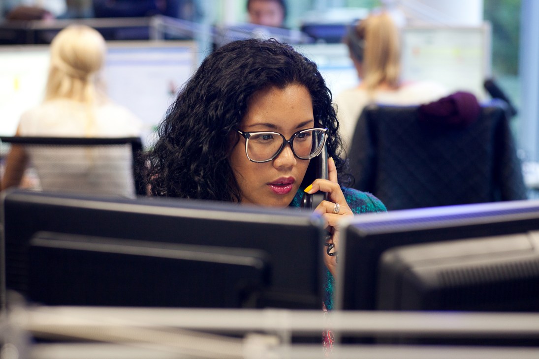Australian journalist Richelle Harrison Plesse working at her desk in the France 24 newsroom.
