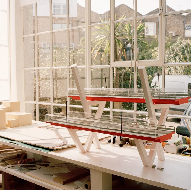 Milan Viaduct project working model displayed on a studio desk with large windows overlooking a courtyard.
