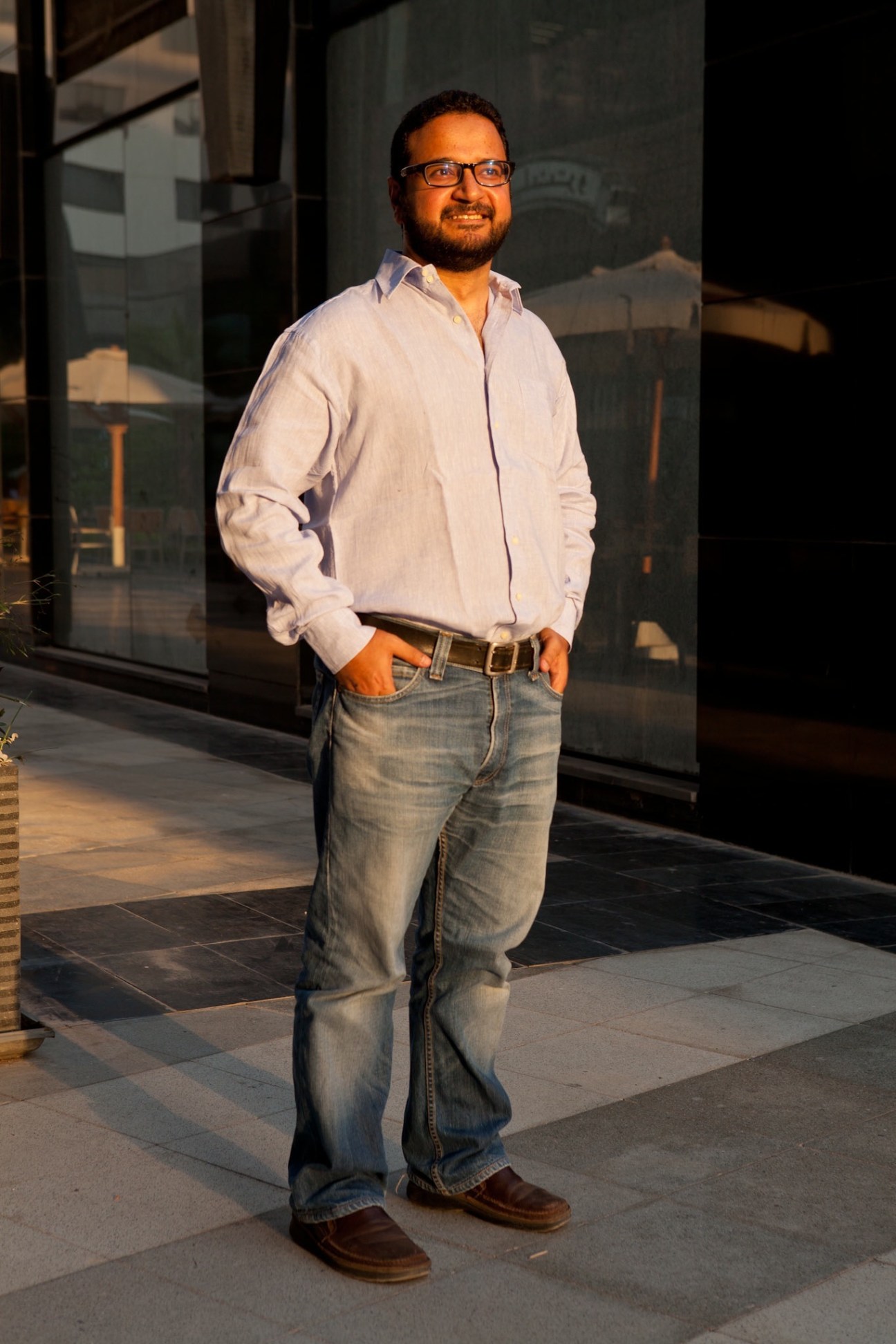 Mohammad Omara, founder of Fascila Technologies, stands outdoors wearing glasses, white shirt and jeans.