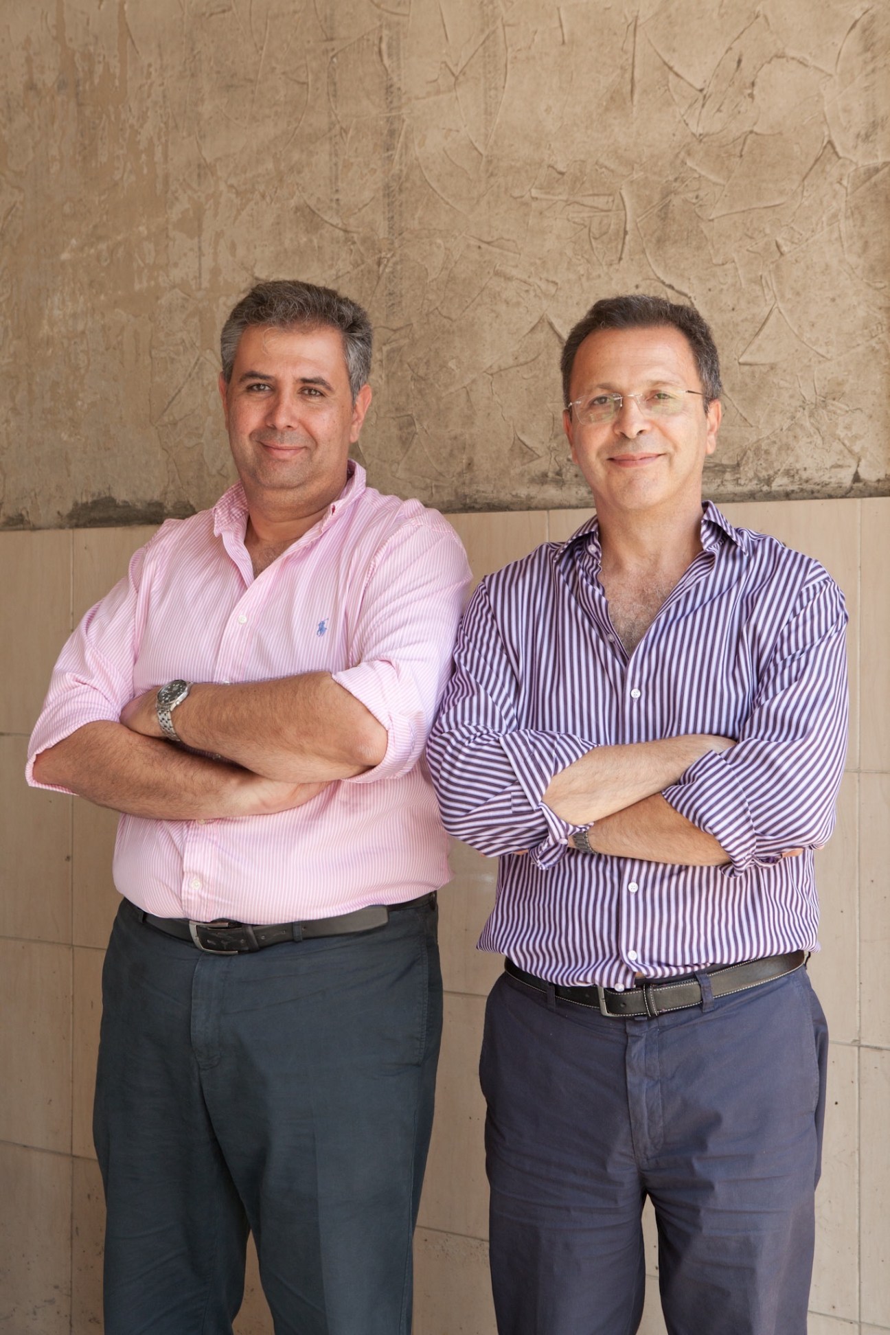 Jalal Abu-Gazaleh and Amgad Sultan, co-founders of Gourmet Egypt, posing together against a textured wall.