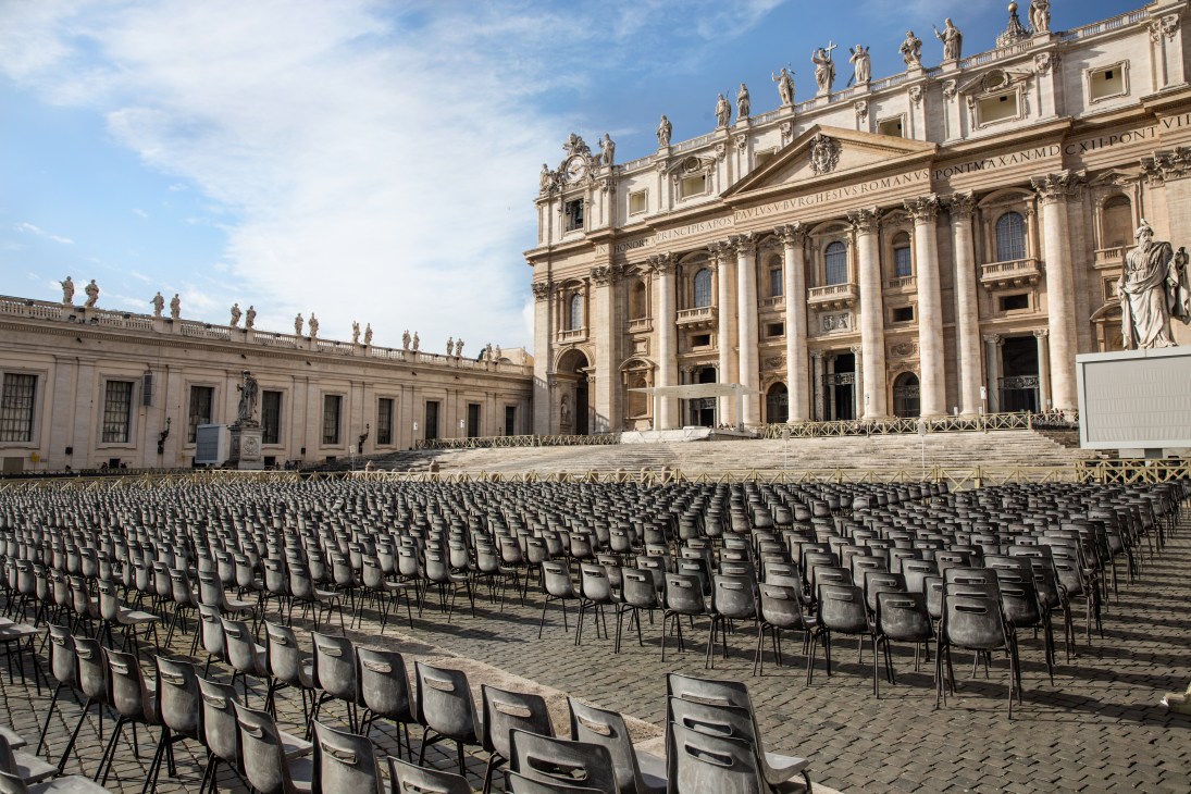 Rows of empty chairs fill St Peter's Square in front of the basilica's facade ahead of a papal mass.