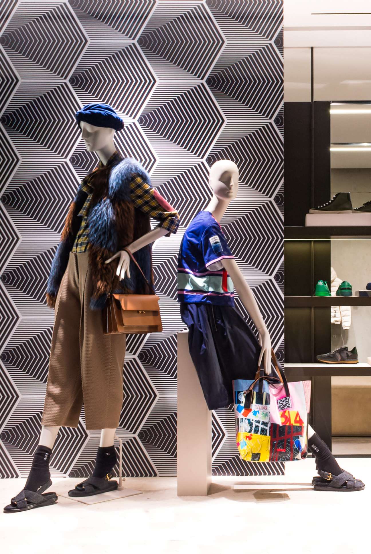 Two mannequins displaying womenswear at Eraldo boutique with geometric patterned backdrop.