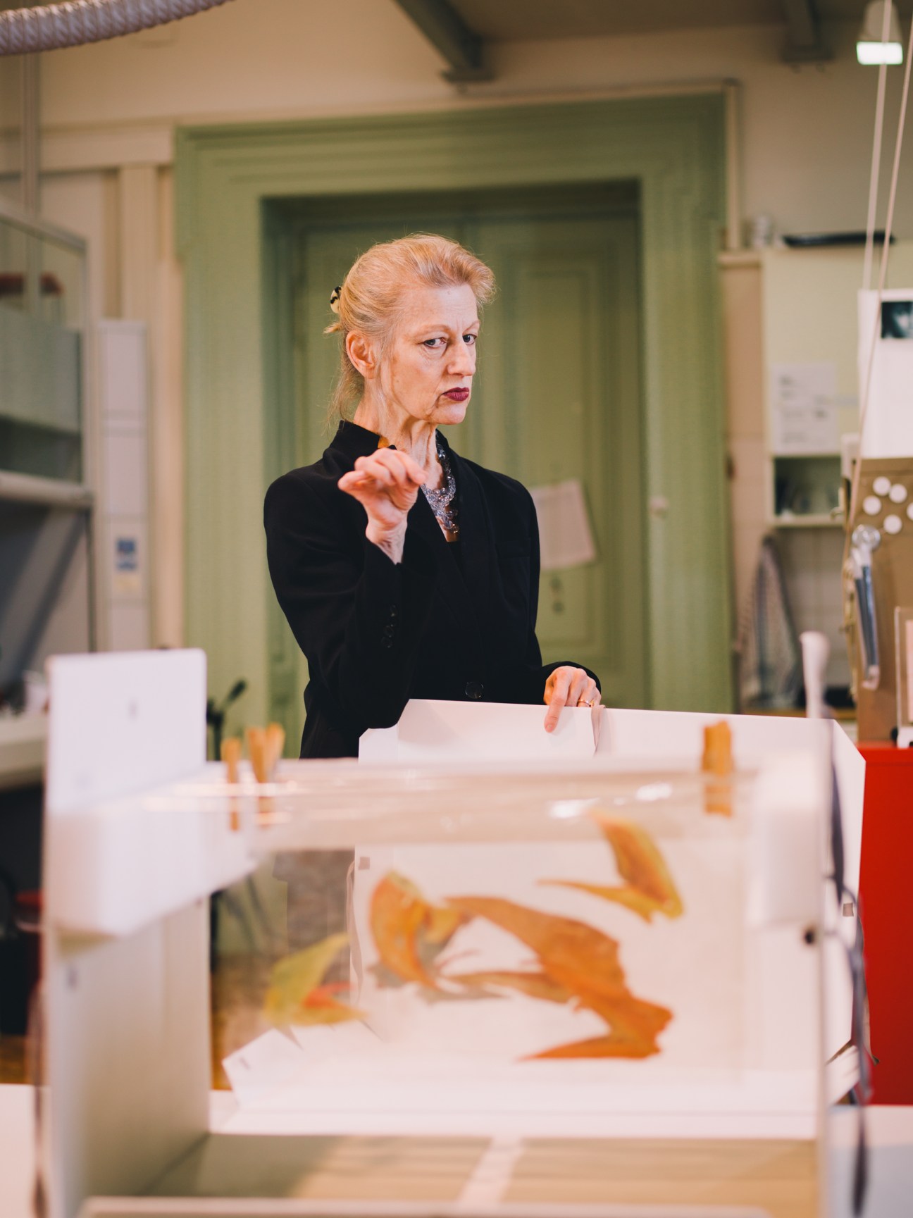 Contemporary-art conservation and restoration professor Gerda Kaltenbruner speaking in her studio with artworks on display.