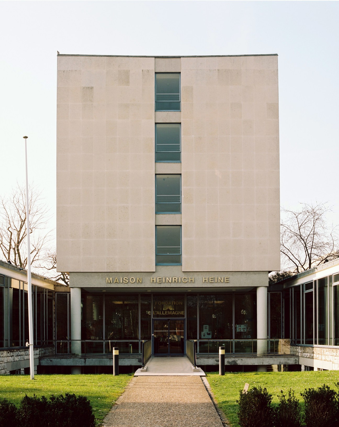 Maison Heinrich Heine, Germany's modernist residence building with beige stone facade and vertical window strip.