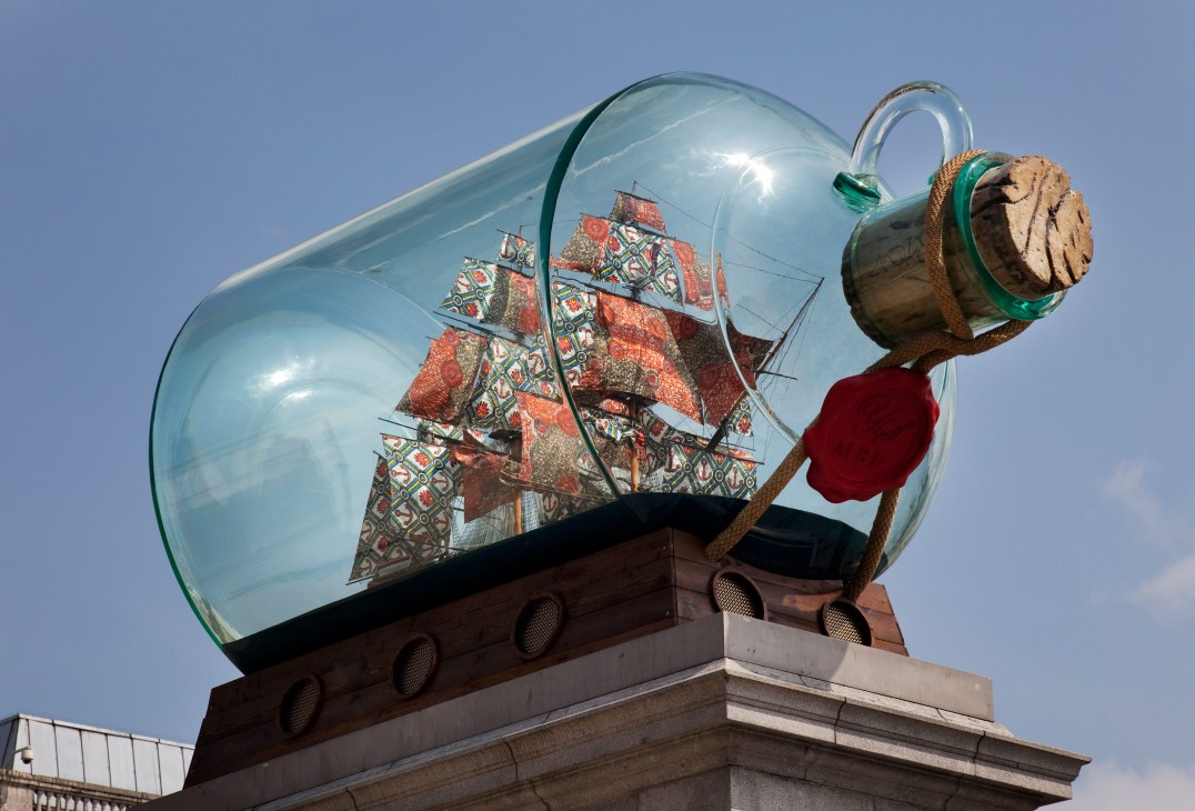 Yinka Shonibare's 'Nelson's Ship in a Bottle' sculpture displayed on the fourth plinth in Trafalgar Square, featuring a ship with patterned sails inside a glass bottle.