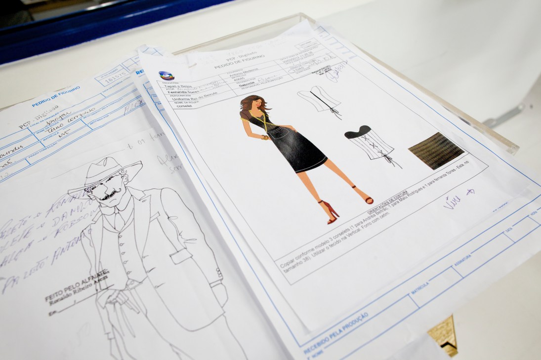 Costume design sketches and fabric swatches on documentation forms at Projac studios.