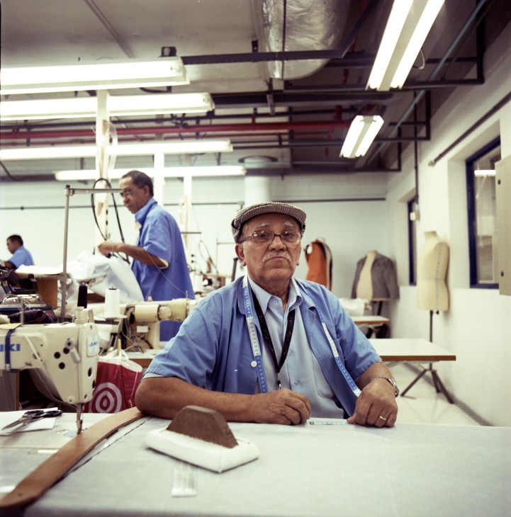 A tailor works at a sewing machine in Projac's costume department workshop.