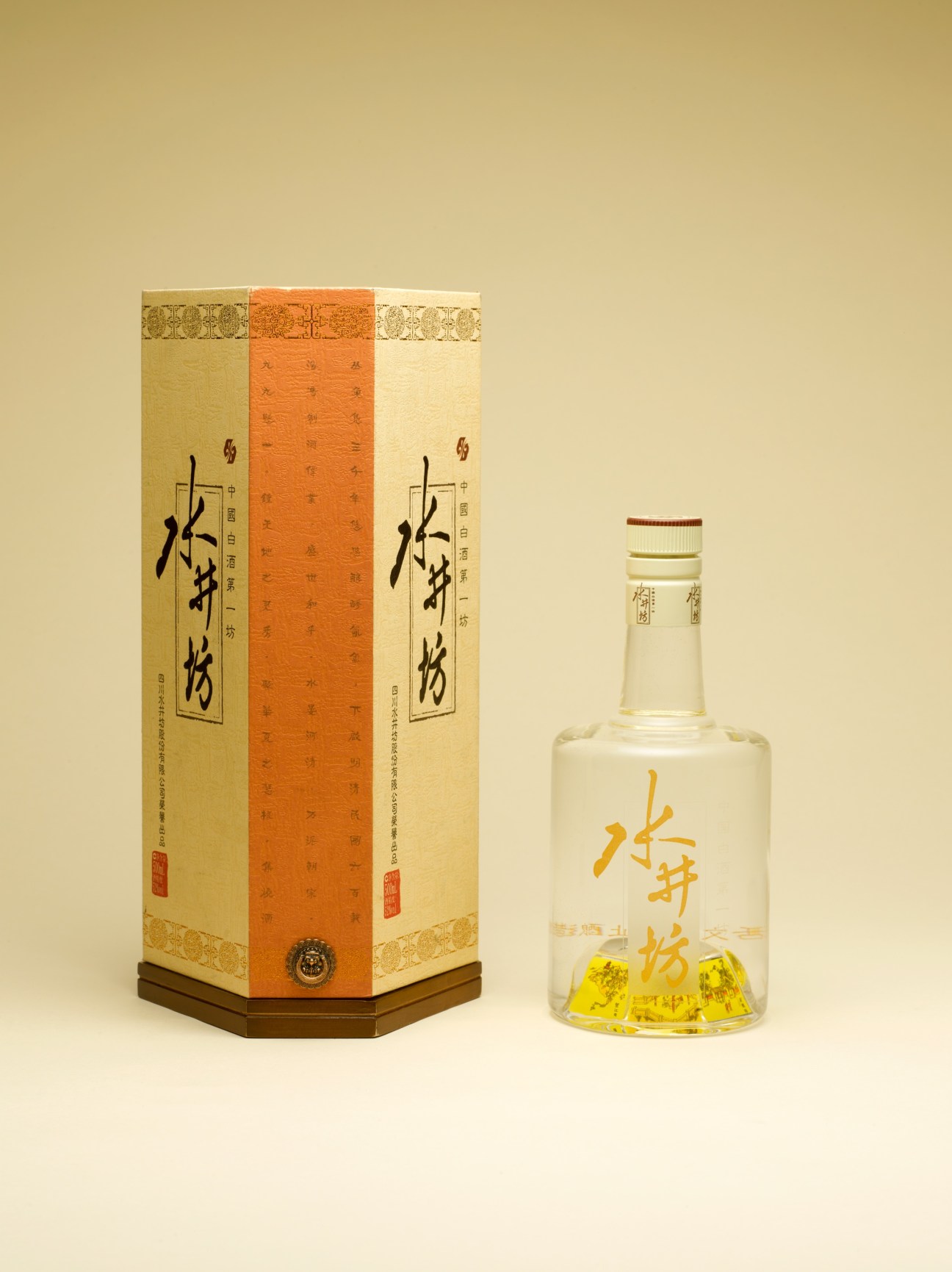 Swellfun bai jiu bottle with wooden-base-inspired packaging and decorative box with orange center panel.