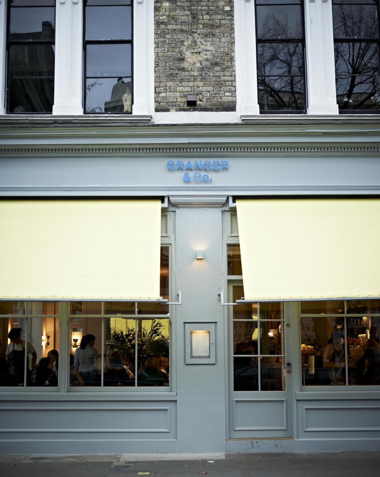 Granger & Co restaurant storefront on Westbourne Grove in London with blue signage and large windows.
