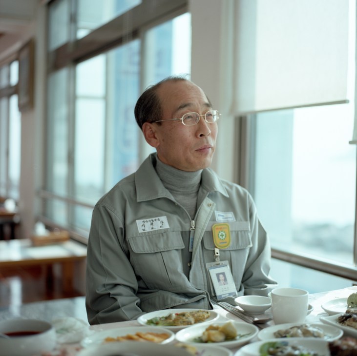 Ki Won-Kang, DSME's chief production officer, sits at a table with food during an interview.