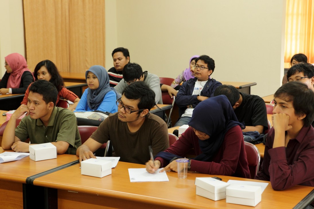 Students seated at desks during a lecture or classroom session at Gadjah Mada University in Yogyakarta.