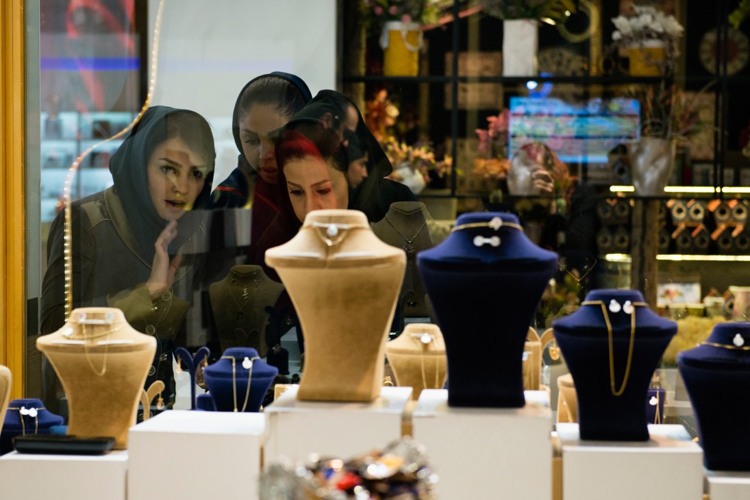 Women browse jewelry displays at Golestani jewellery store in Palladium mall.