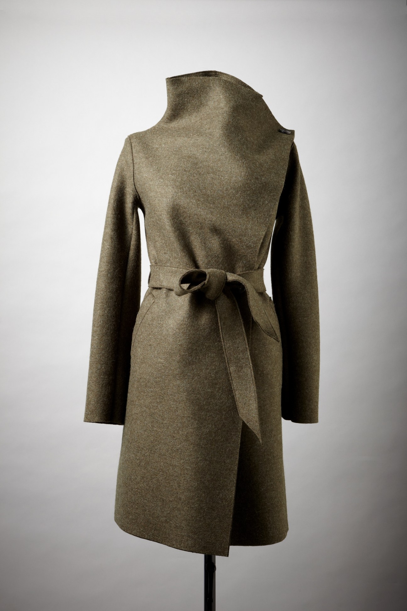Olive-green felted wool coat with long sleeves and tied waist belt on mannequin.