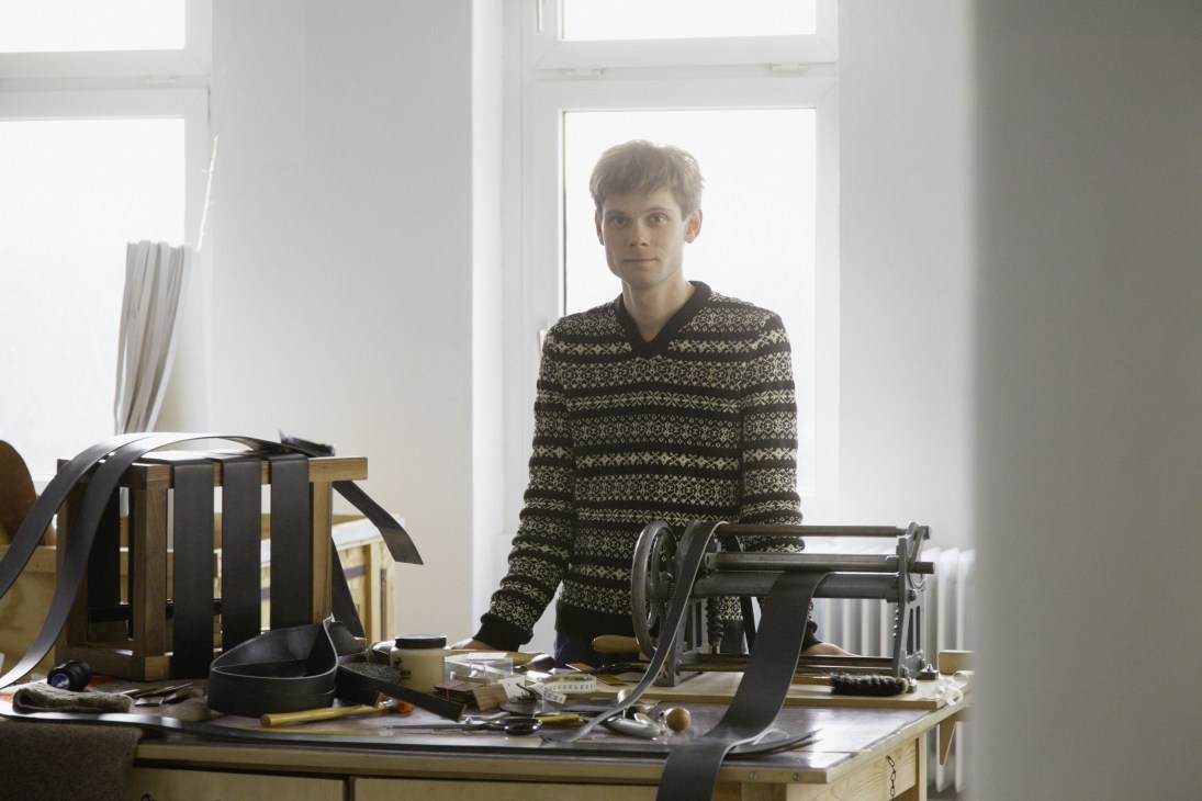 Daniel Heer stands in his Berlin shop surrounded by luxury horsehair mattress materials and equipment.